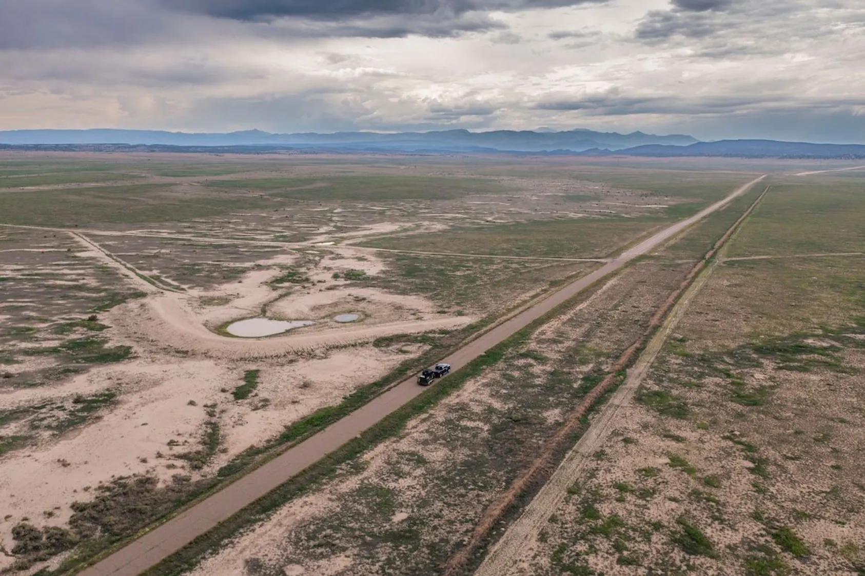 Aerial view of rural property showing access roads, boundaries, and undeveloped land, illustrating the importance of surveying and understanding property layout