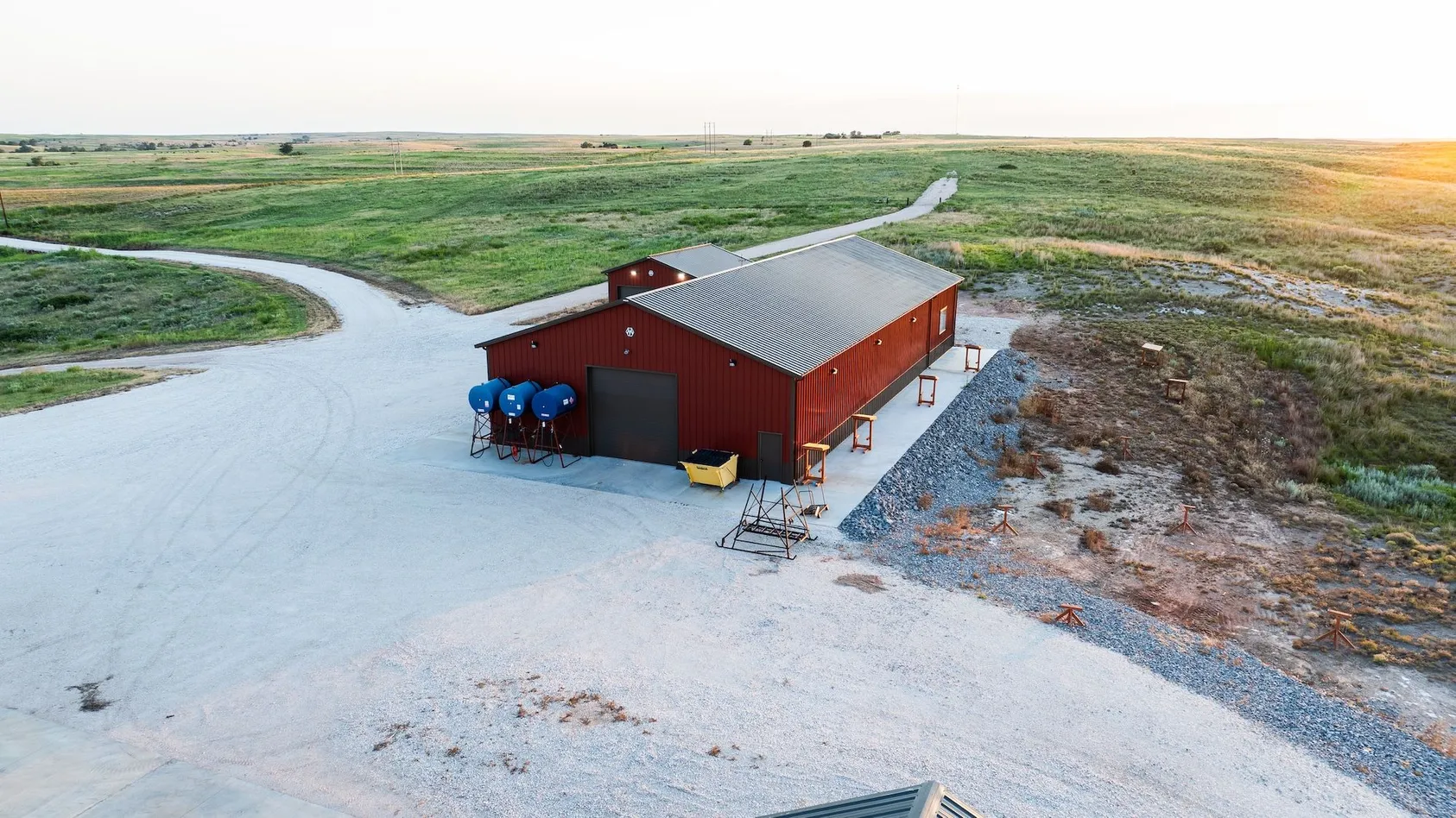 Aerial view of farm property with red barn and outbuildings surrounded by agricultural fields, illustrating complete farming operation and infrastructure value
